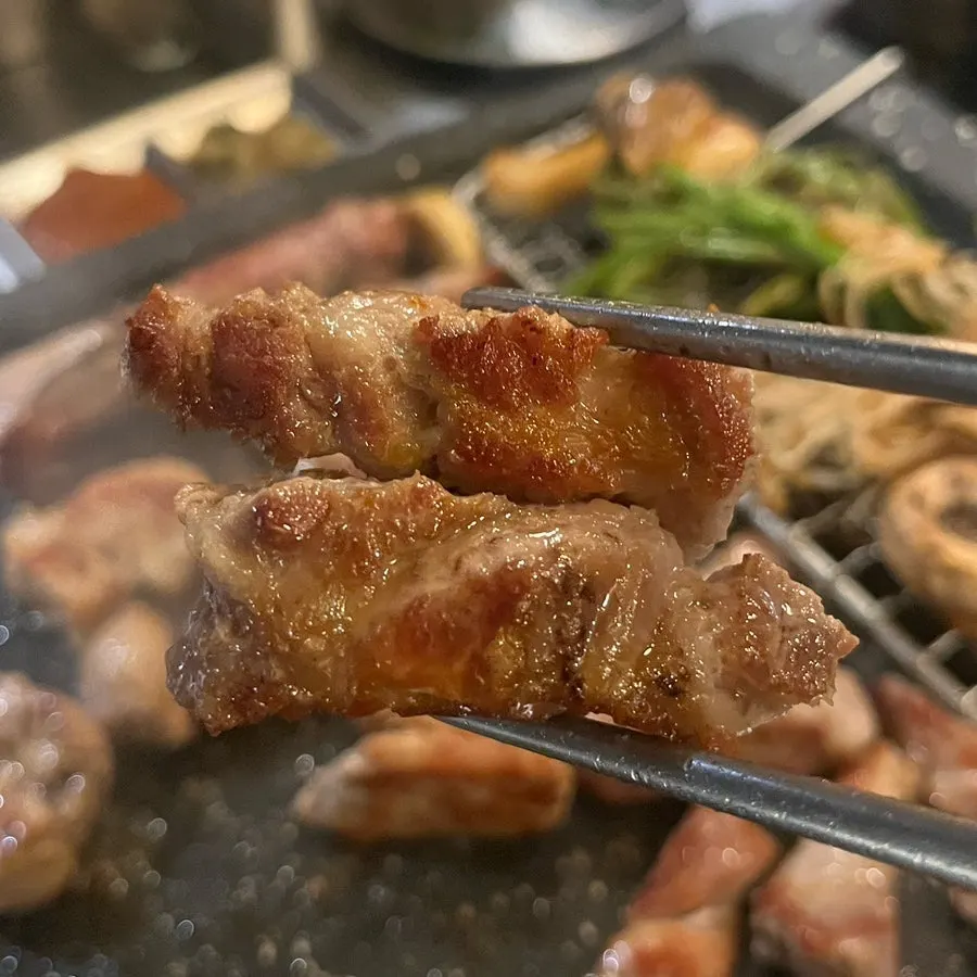 Chewy pork dipped in melgeot sauce