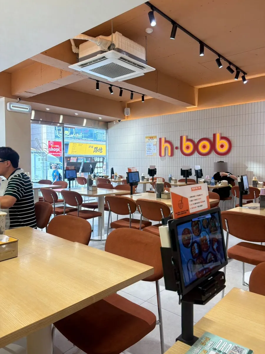 Interior of Bap Jangin Hongdae Branch with two-top and four-top tables