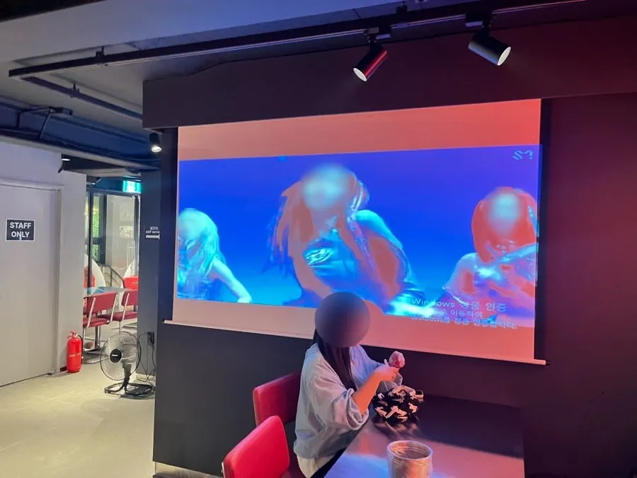 Large 2nd-floor screen playing music videos