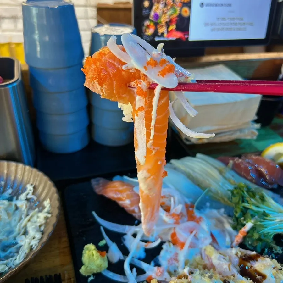 A plate piled high with Couple A Plus sushi