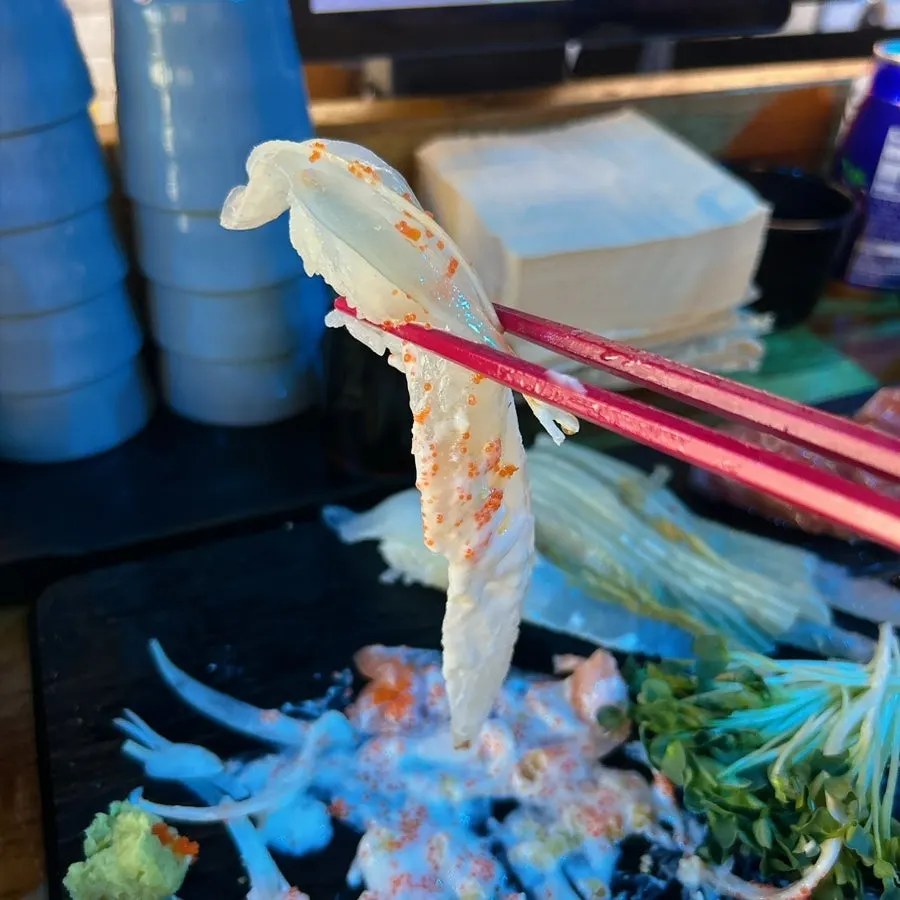 Long-tail sushi with fish stretching well past the rice