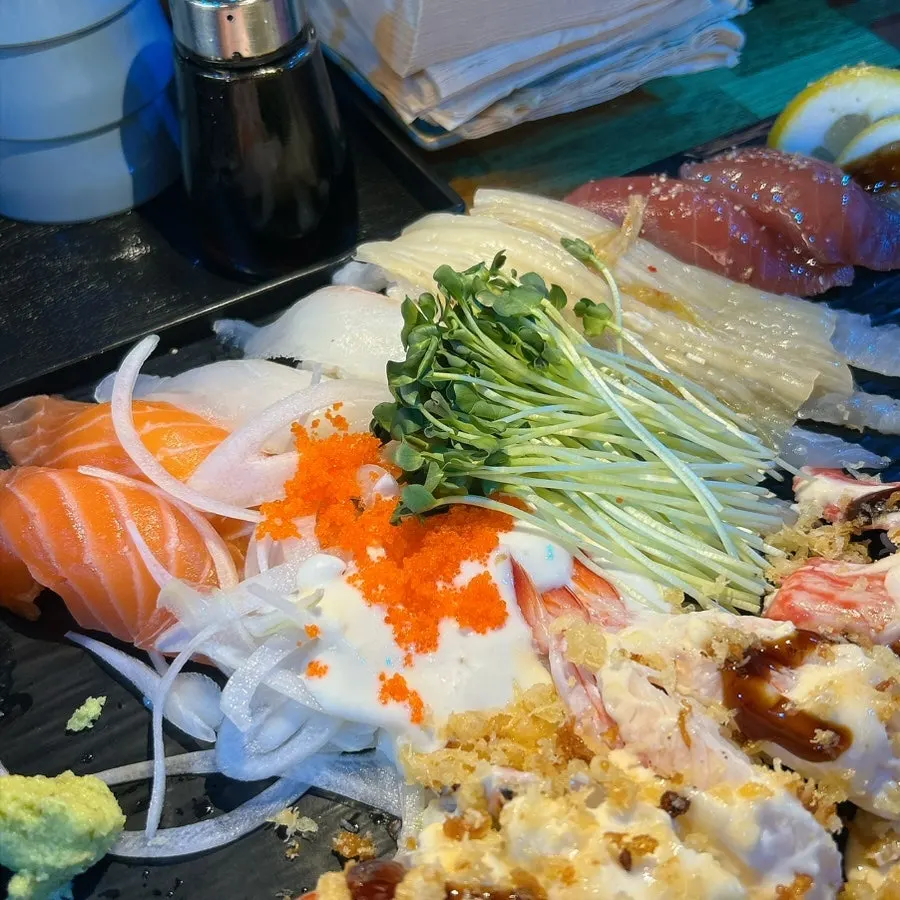 Plate of sushi next to the soy sauce brush