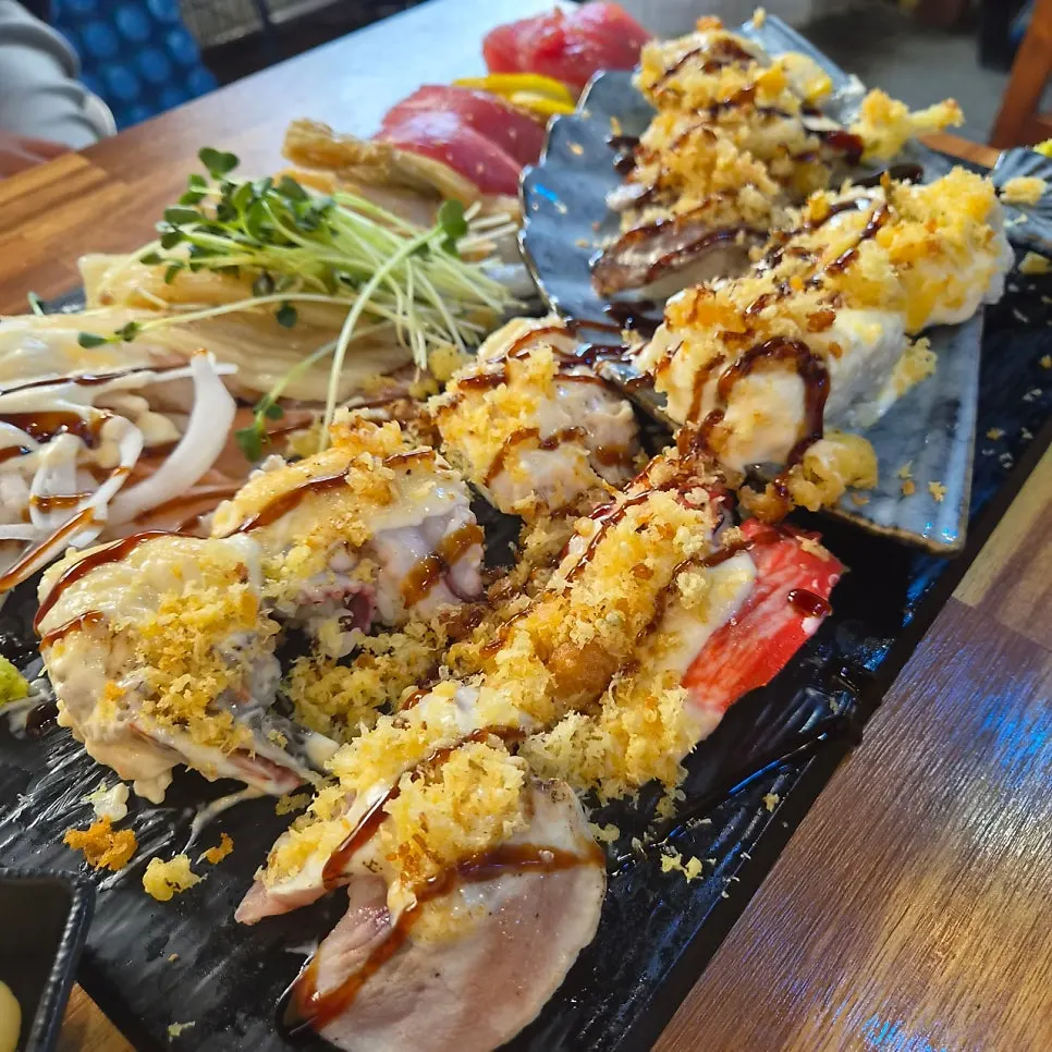 Couple A Plus plate filled with sushi and rolls