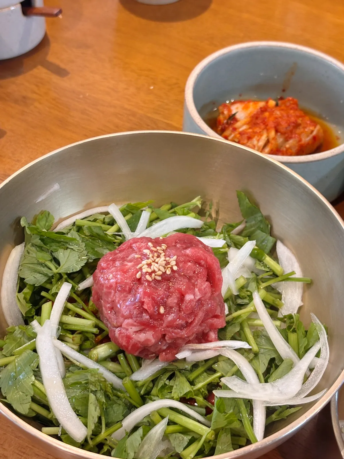 Hanwoo yukhoe bibimbap served in a brass bowl