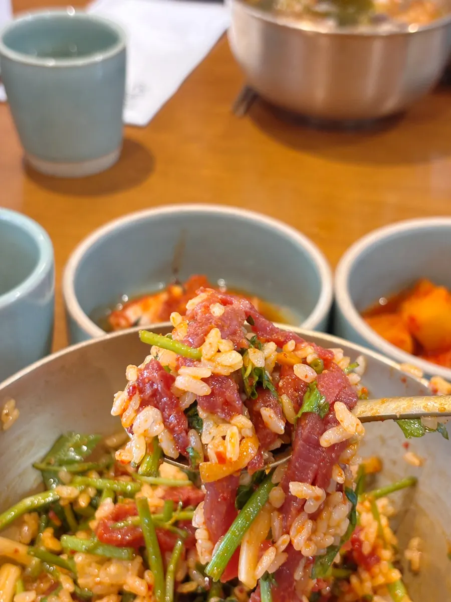 Yukhoe bibimbap mixed until the sesame oil aroma rises