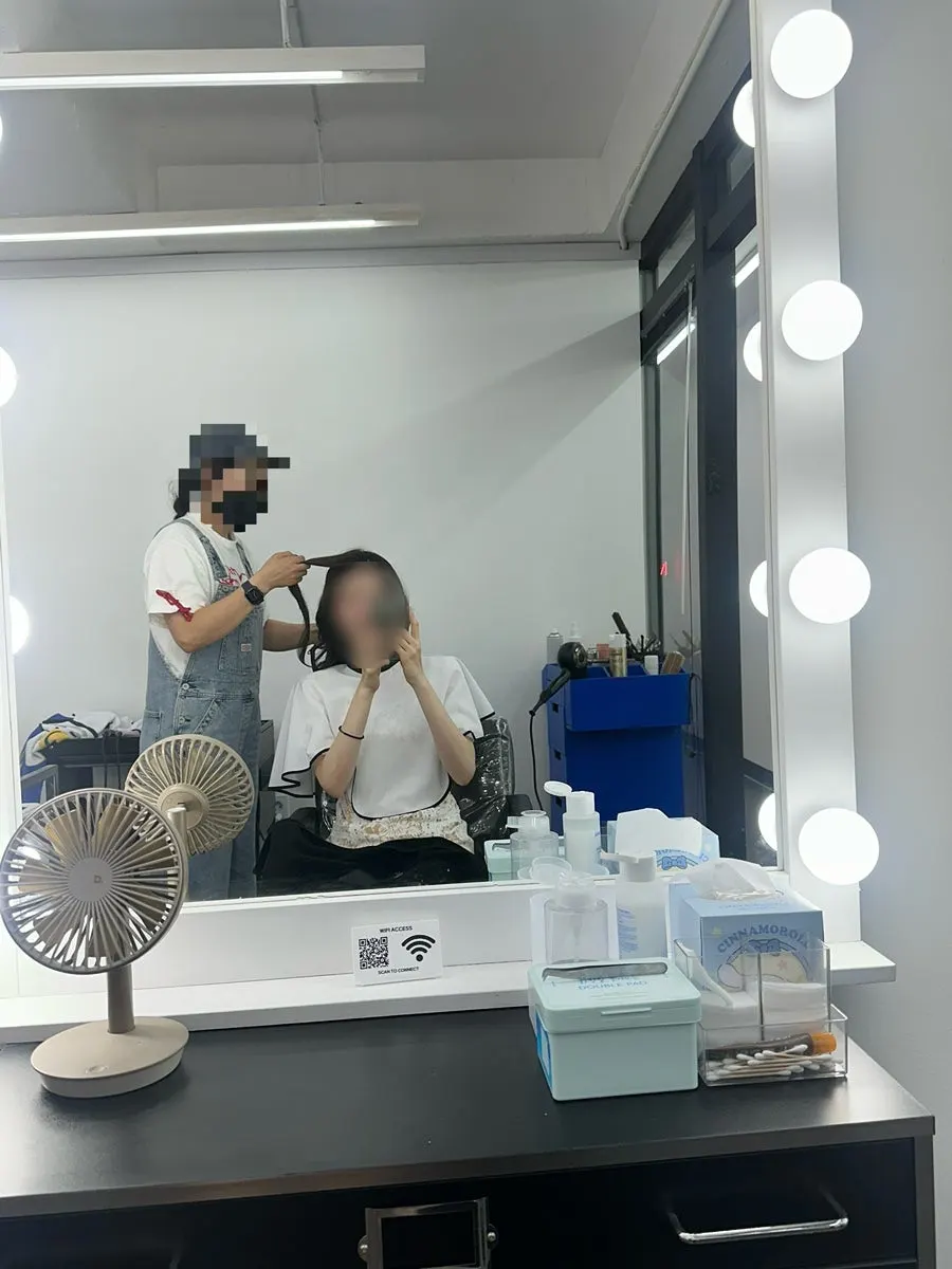 Wavy hair with slight volume tied at the back