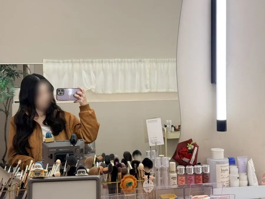 Finished face reflected in the mirror after makeup