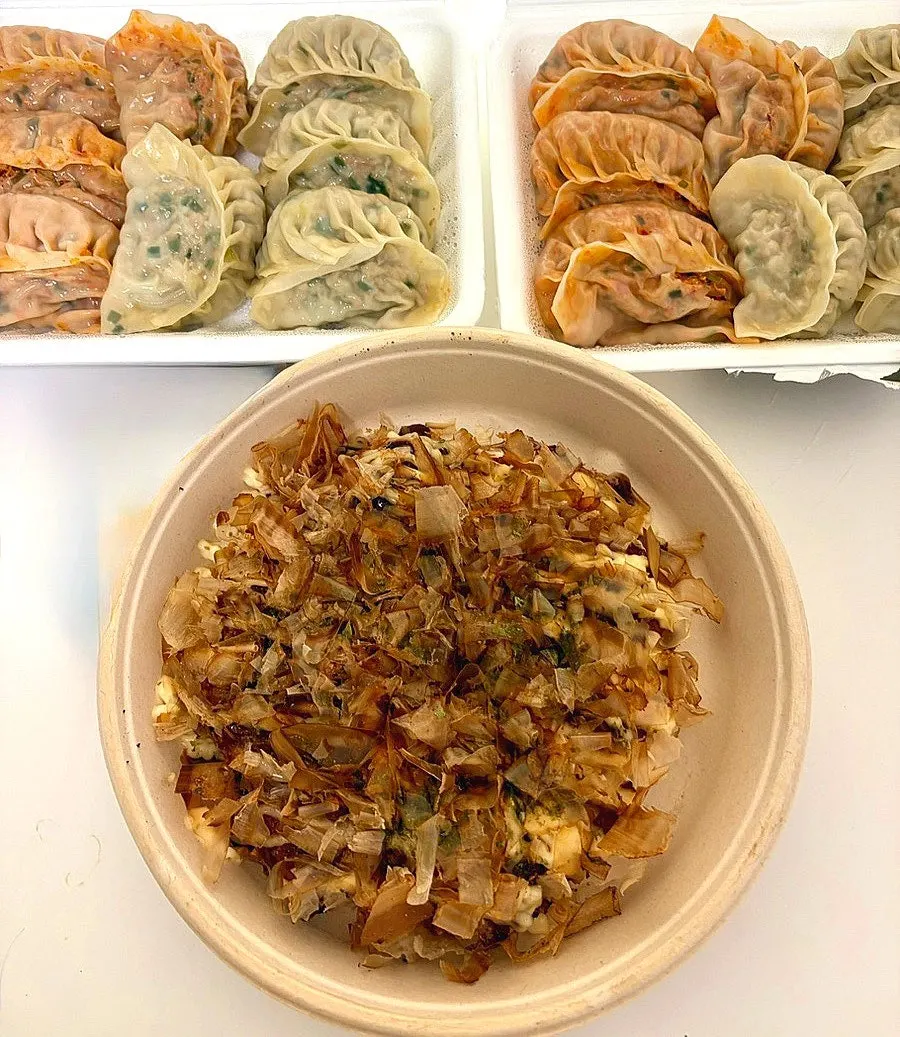 Opened container of steamed dumplings
