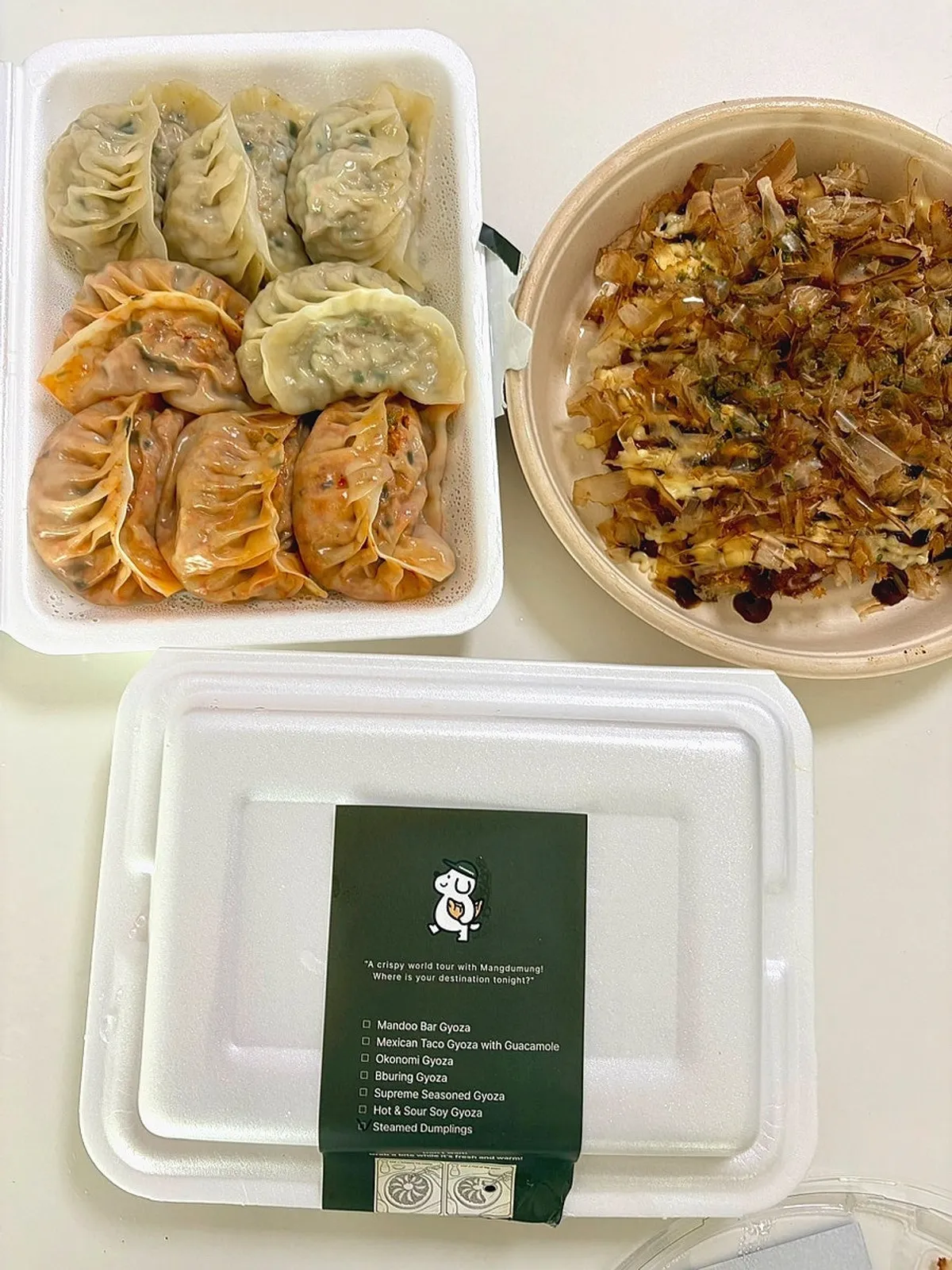 Eating MANDOO BAR's okonomi gyoza at home