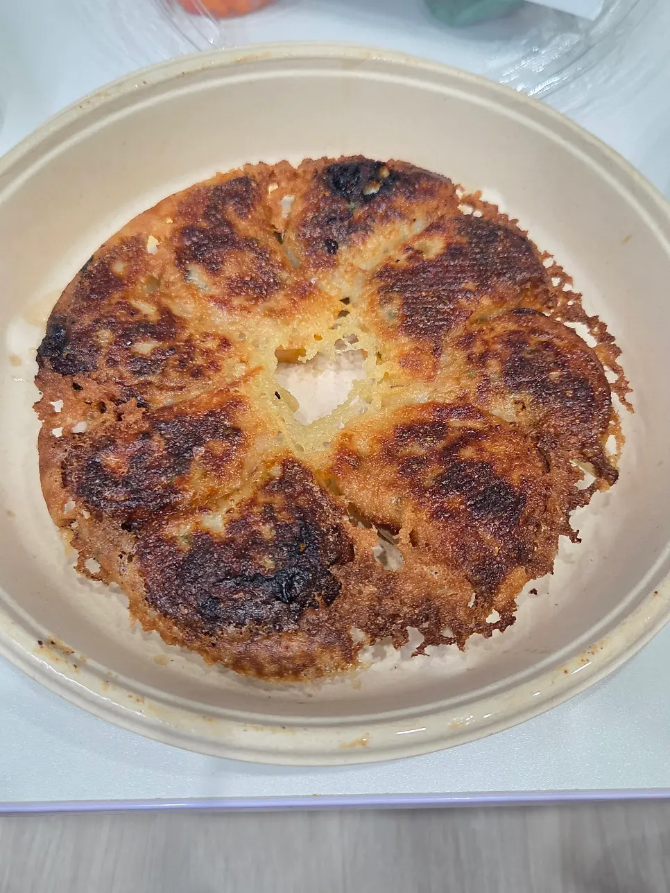 Takeout gyoza from MANDOO BAR with the lid opened