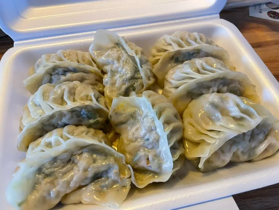 Plump handmade steamed dumplings in a container
