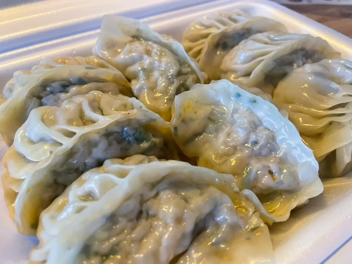 Close-up of a steamed dumpling packed with filling