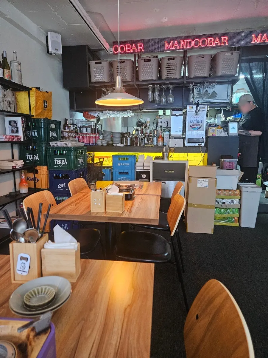 Window seating at MANDOO BAR open to the alley, street-tent style