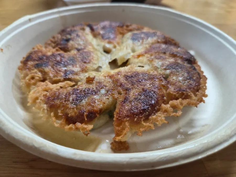 Gyoza served with seasoned pickled radish and soy sauce