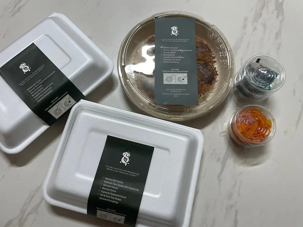Three kinds of MANDOO BAR takeout dumplings unboxed at home