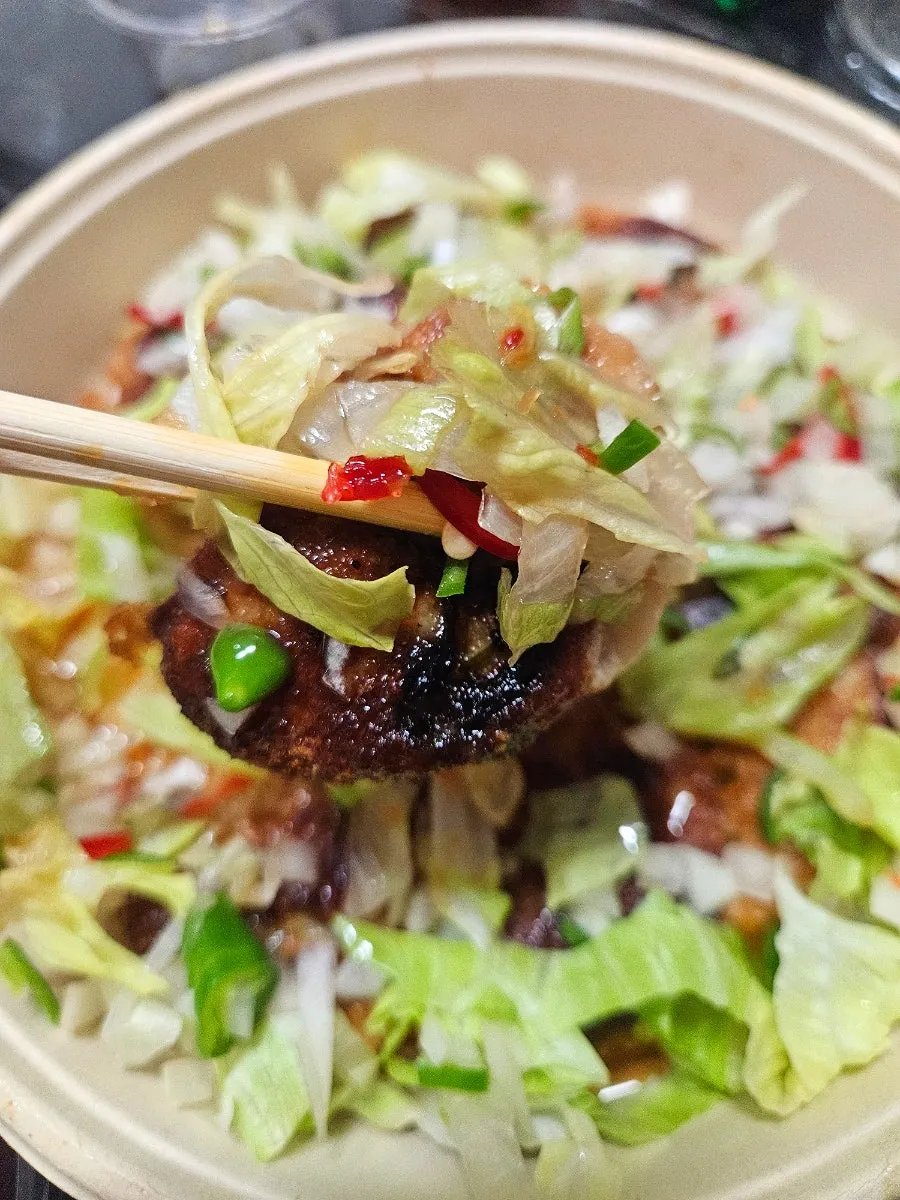 A piece of yurinki gyoza topped with sauce