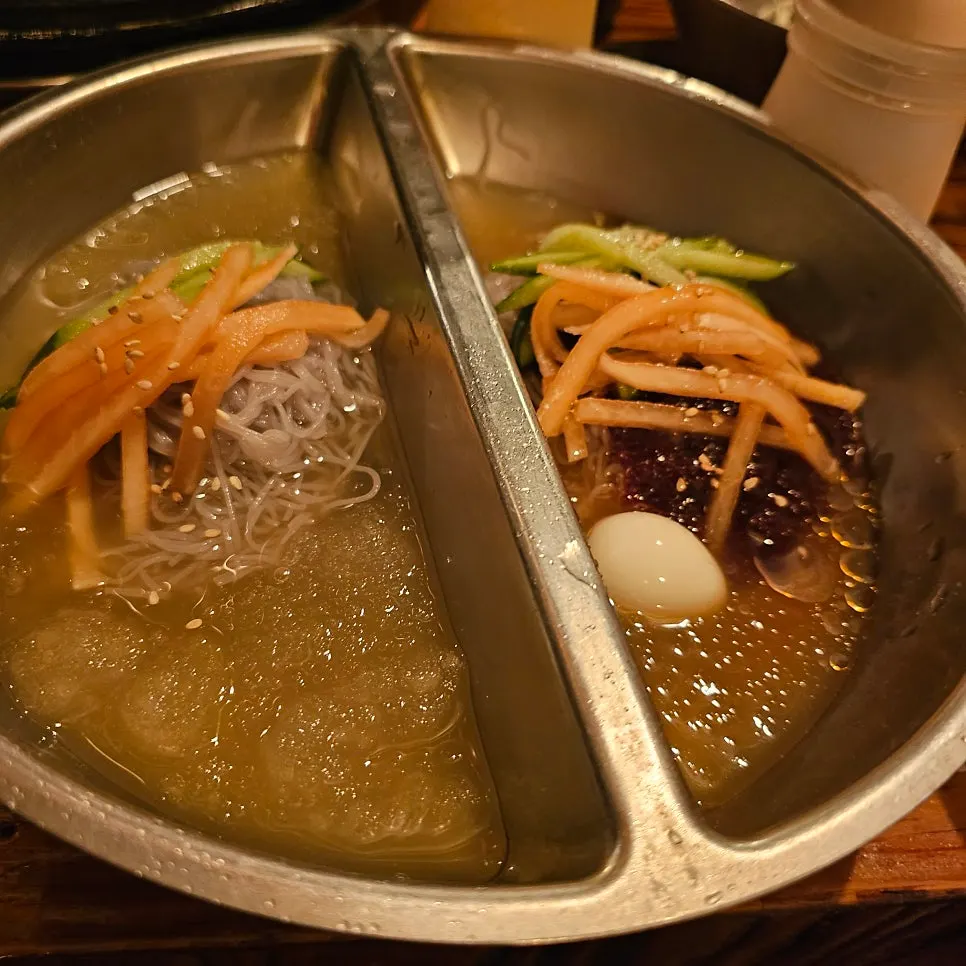 Banban naengmyeon, water and bibim noodles in a divided bowl