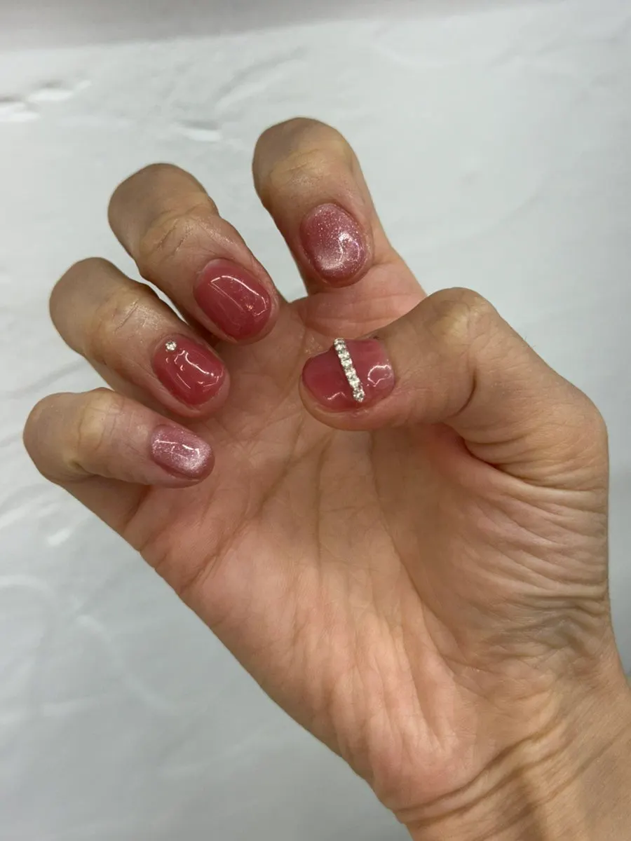 Hand photo of the finished pink gel nails
