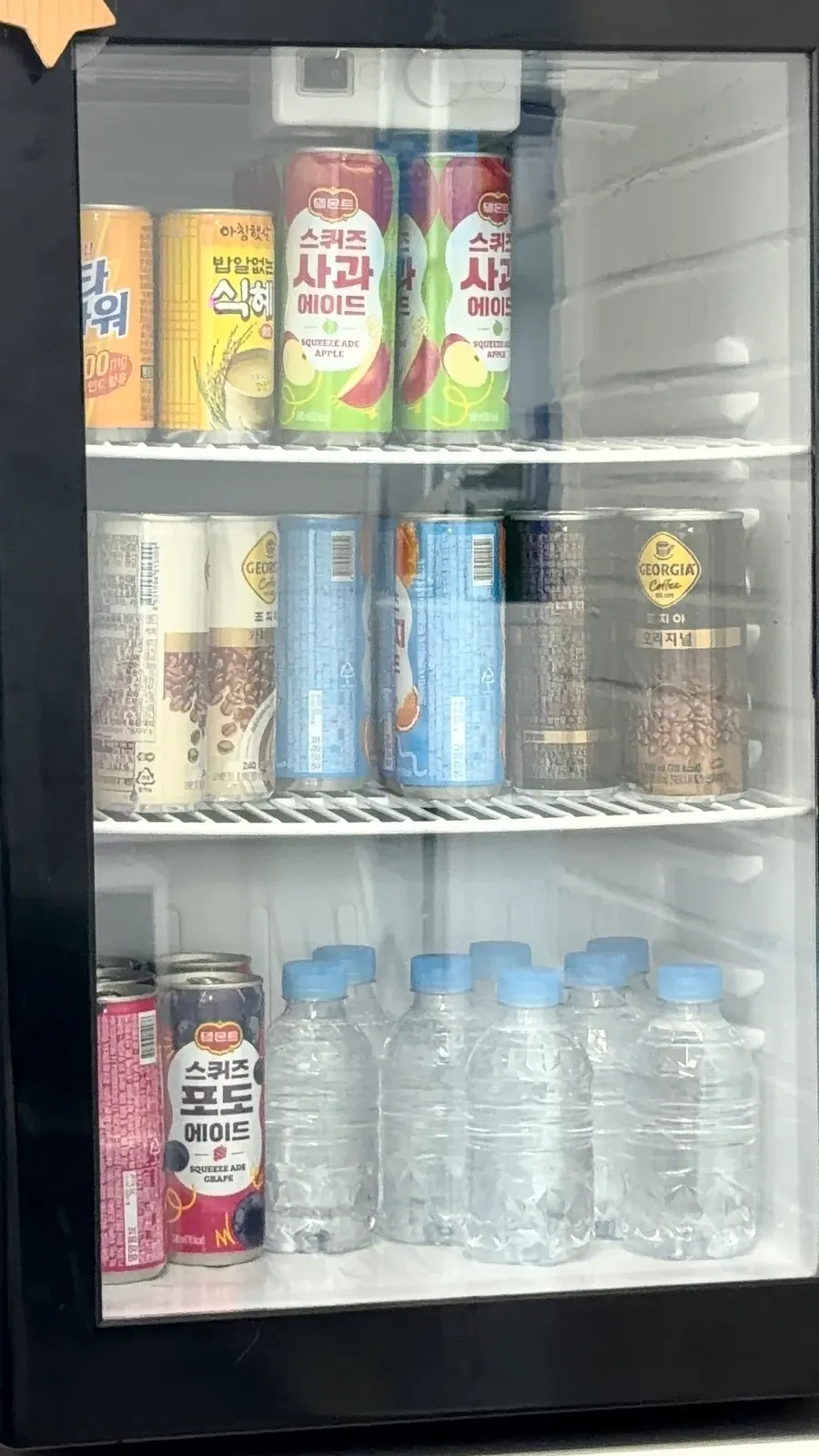 Waiting area and drinks fridge at Byuazeu Hongdae