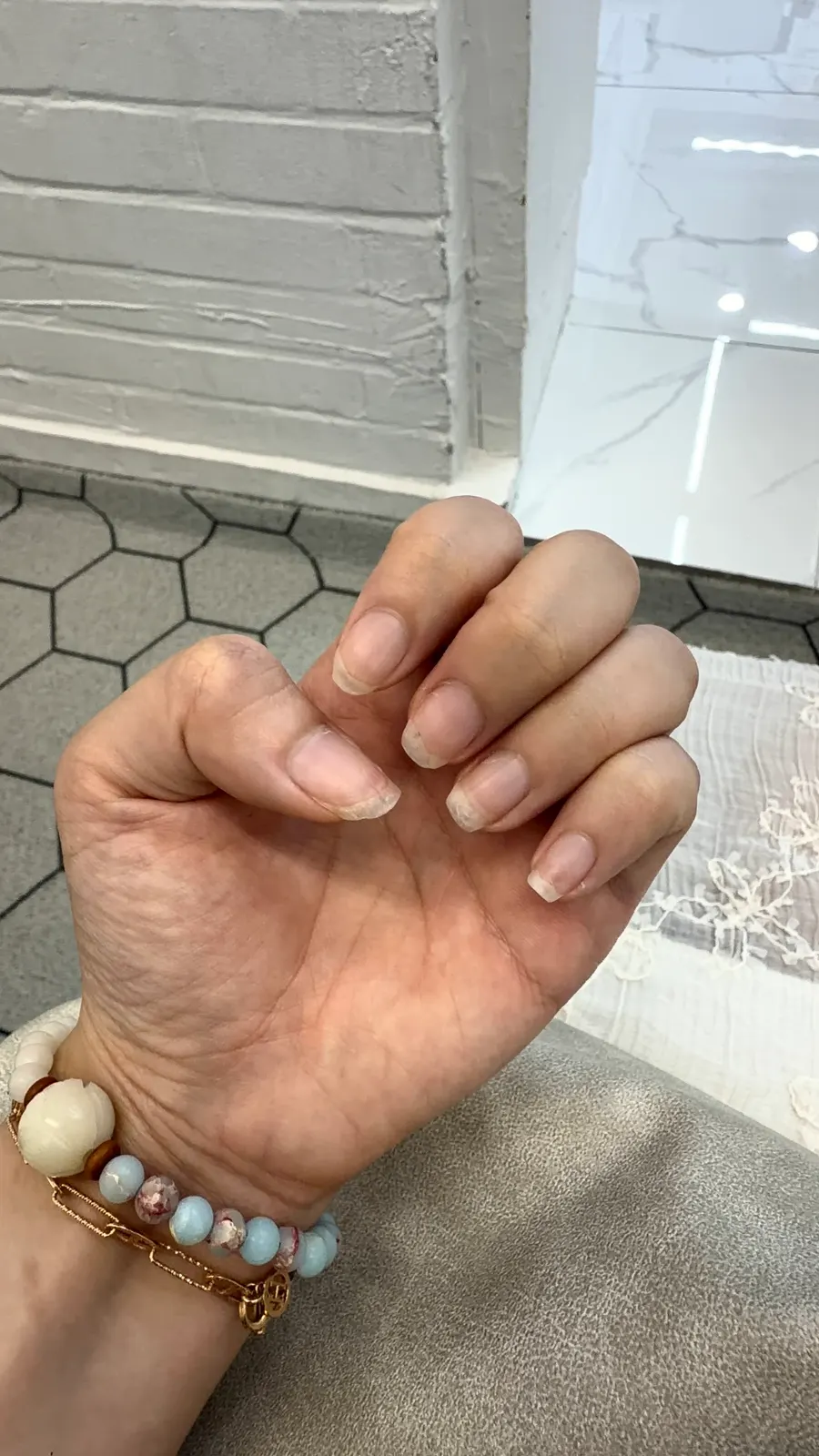 Bare nails, short like chestnuts, before the treatment