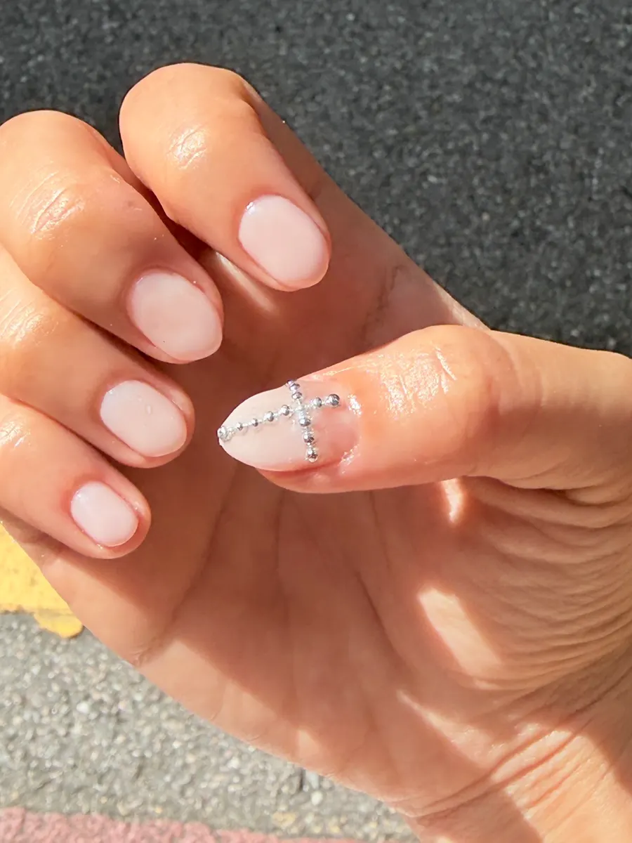Hand showing finished pink gel nails