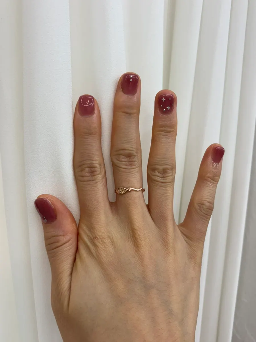Grape-like nails shimmering as the fingers move