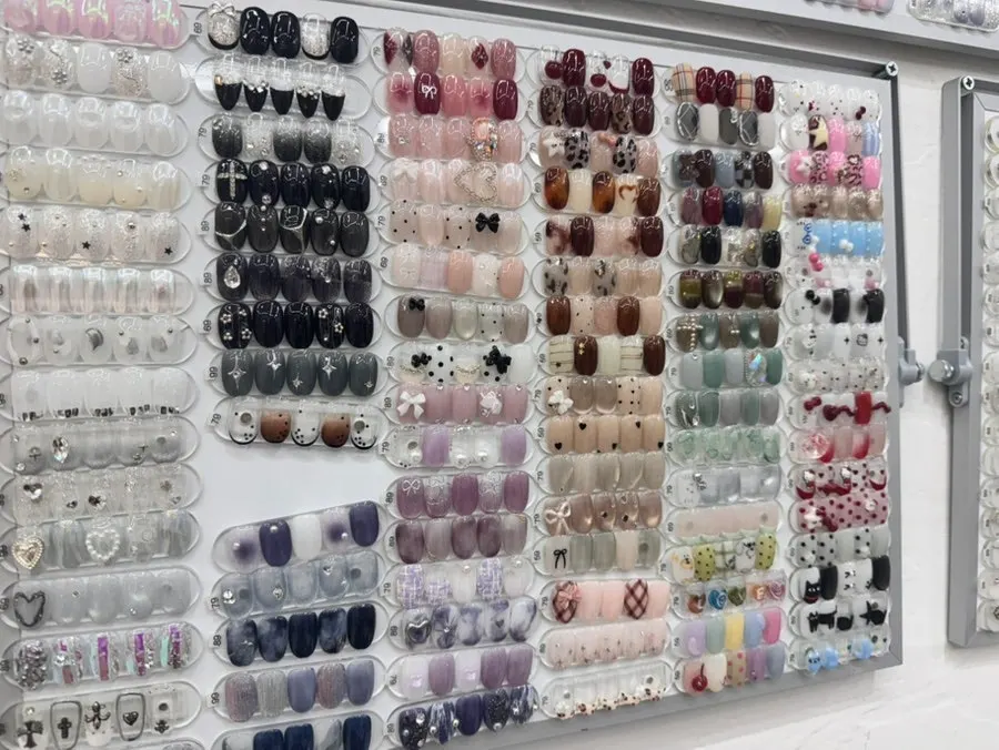Nail art samples pinned on the wall