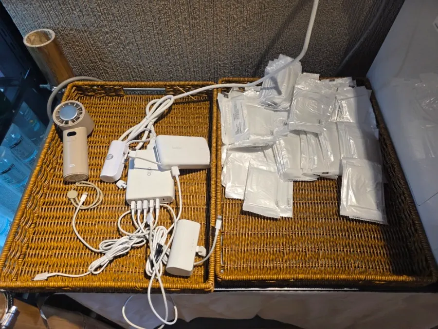 Self-serve corner with aprons, wet wipes, and a phone charger
