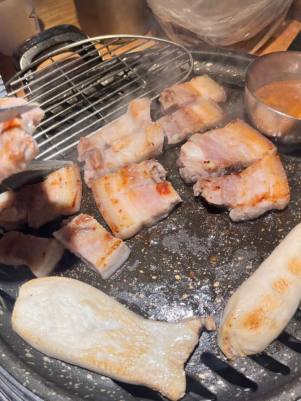 Meat cooking on the grill