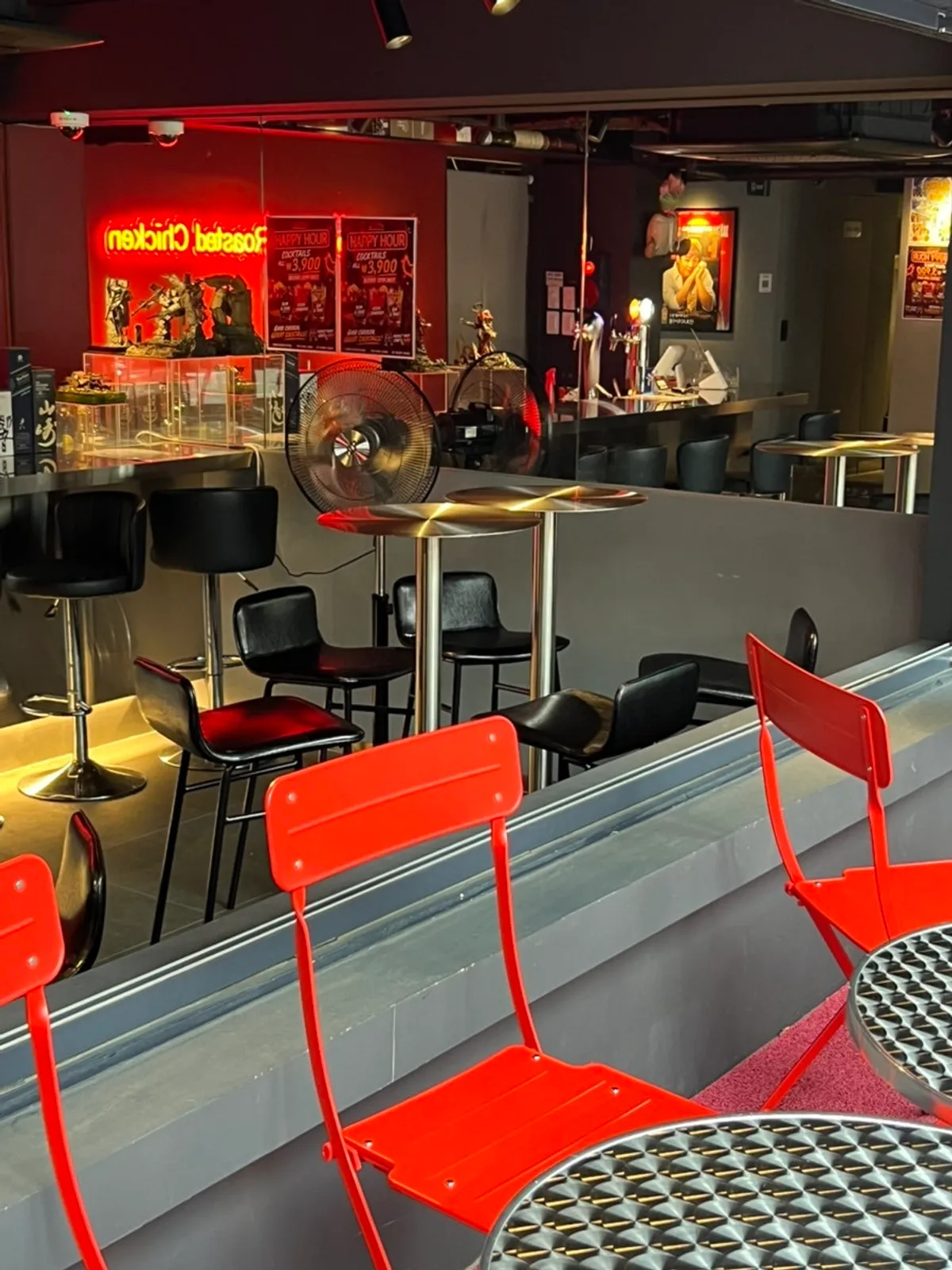 First floor interior with red-toned walls and neon signs