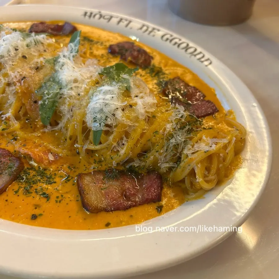Honey rosé pasta topped with bacon and arugula