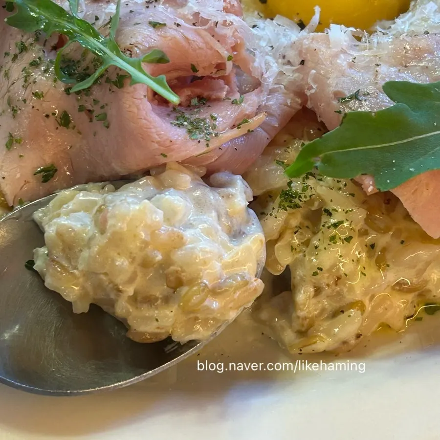 Spoonful of risotto showing the oats mixed in