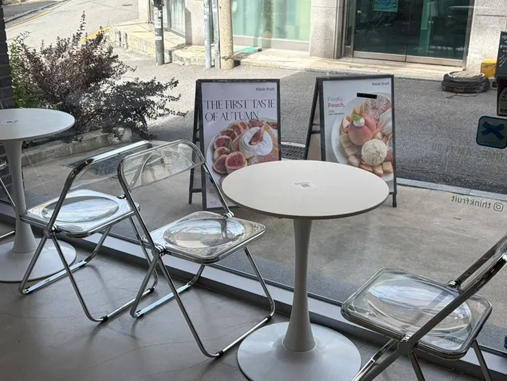 Round window table and clear chairs