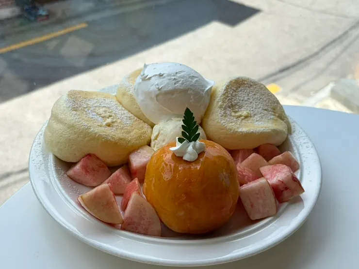 Peach soufflé topped with cream and ice cream