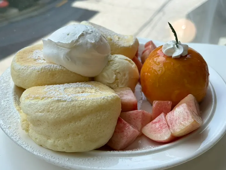 Peach and soufflé topped with cream