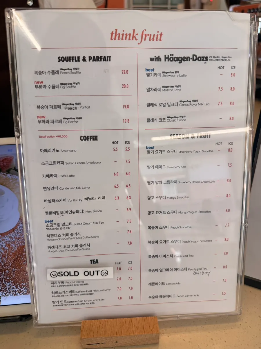 Menu board listing peach and fig soufflé