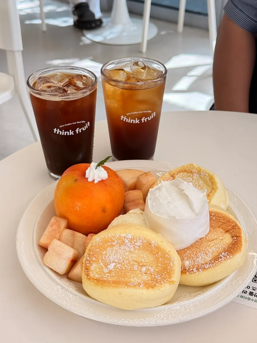 Table setting with peach soufflé and two coffees