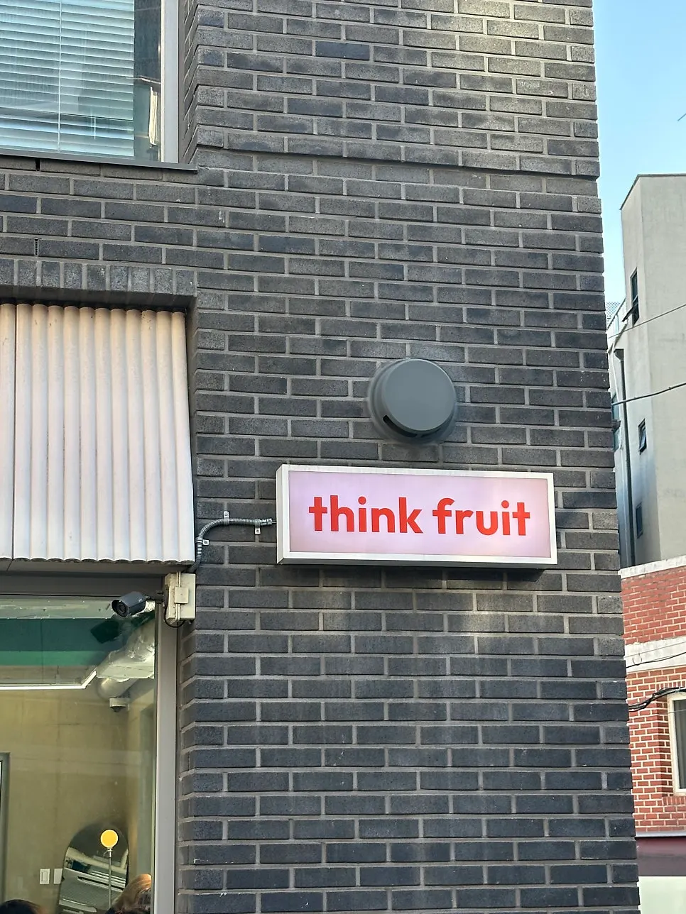 Standing sign outside Think Fruit with a soufflé photo