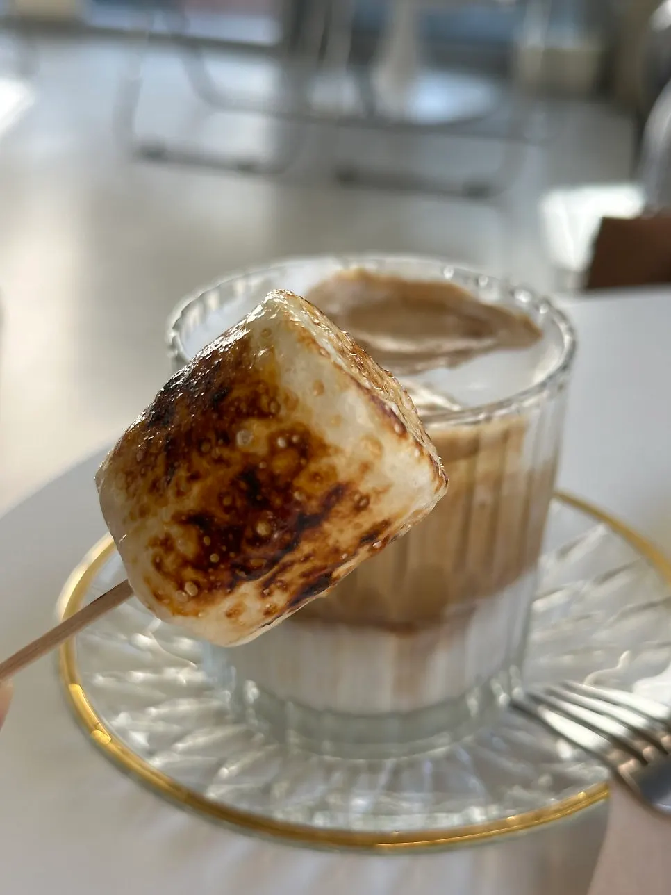 A bite combining pancake, cream, ice cream, and peach