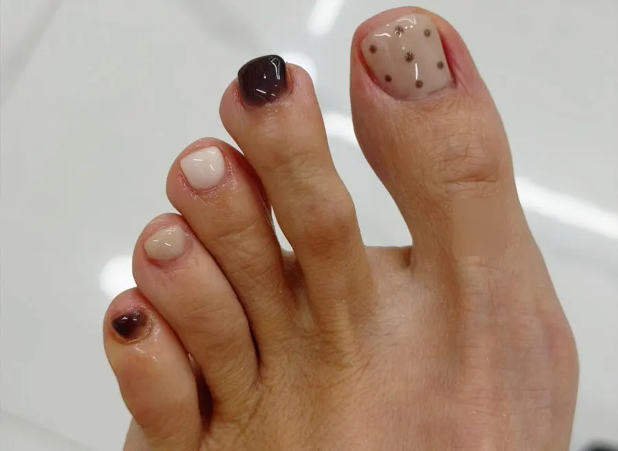 Finished toenails with the monthly art moved from hand to foot