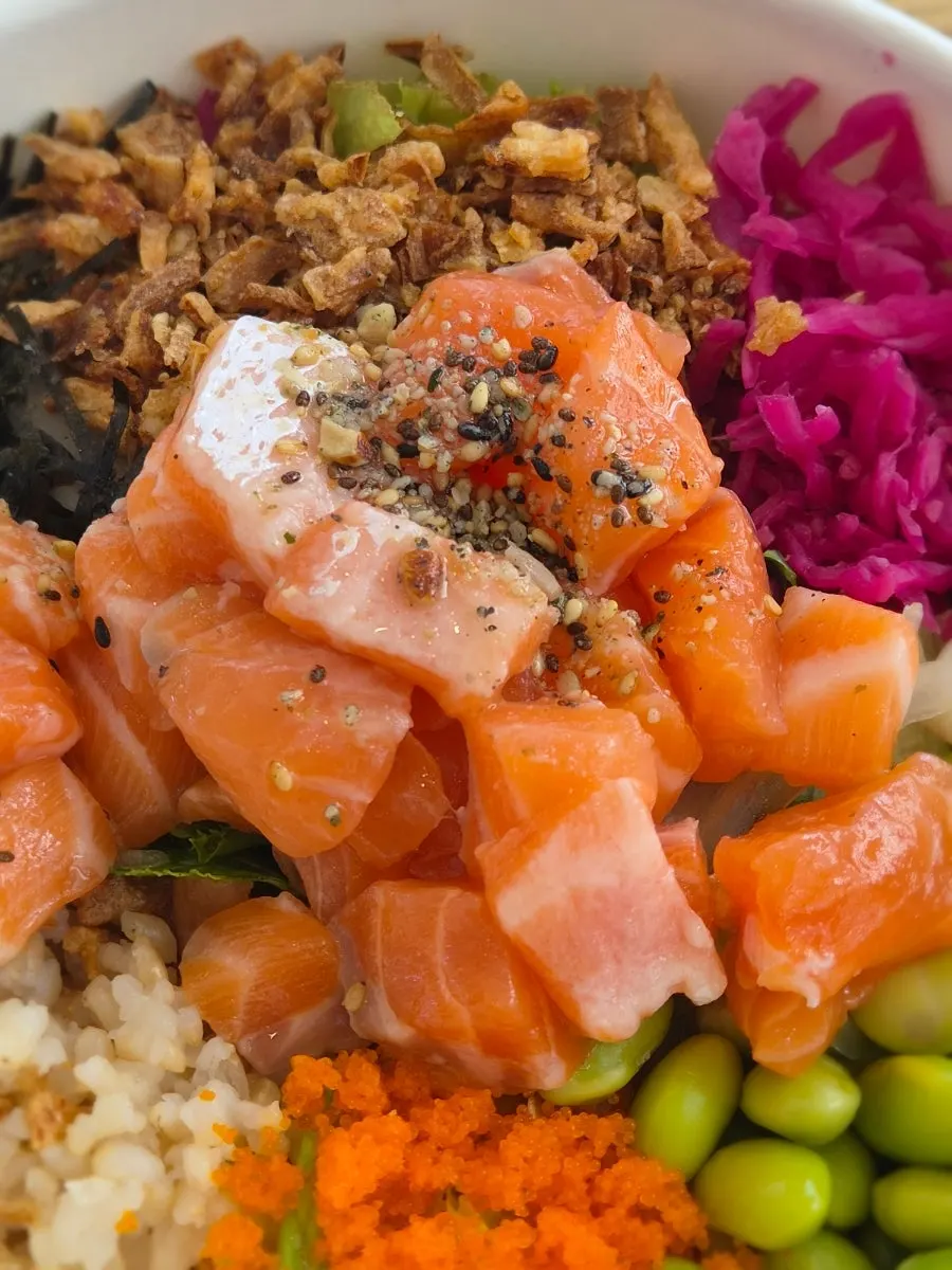 Salmon poke topped with raw salmon and flying fish roe