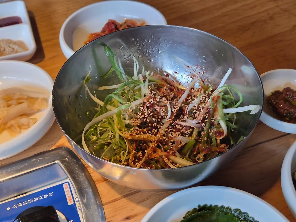 Scallion salad in a stainless steel bowl