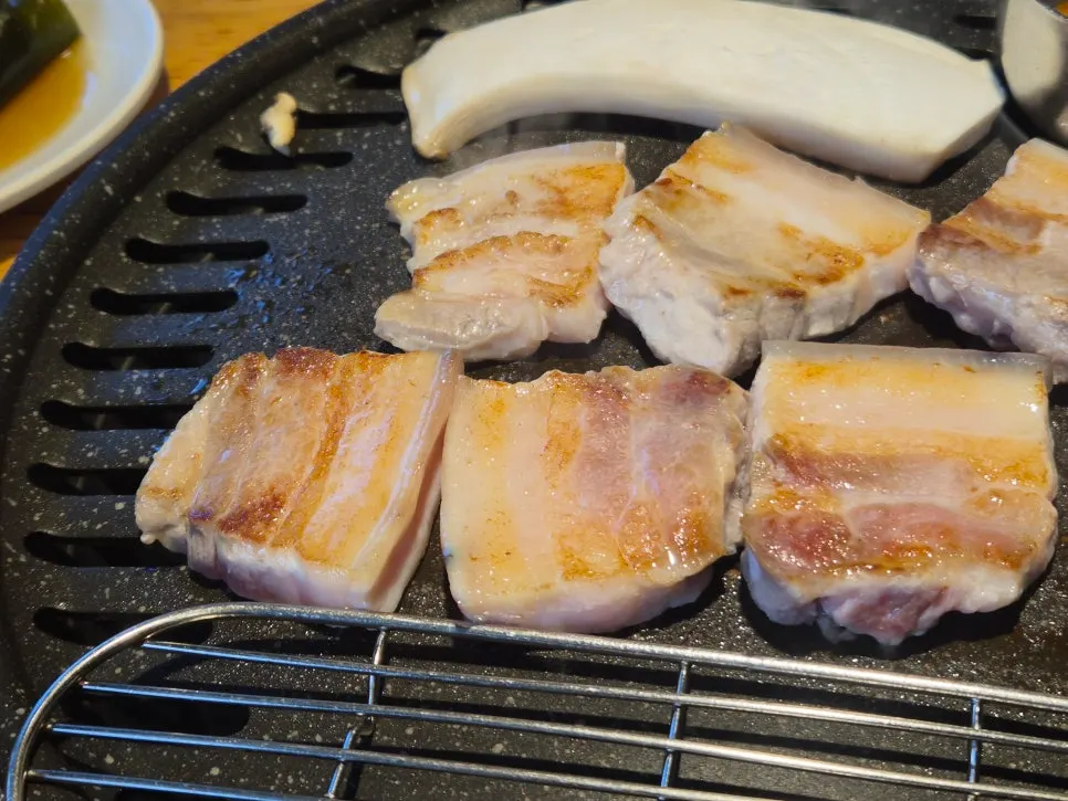 Flipping the ogyeopsal after it browned nicely