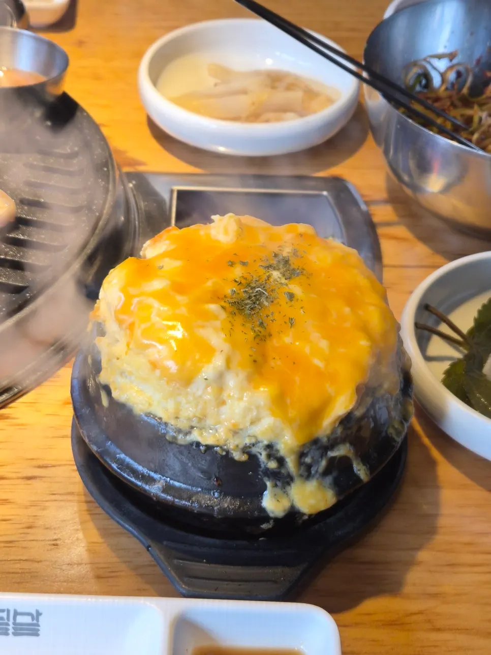Double cheese egg custard puffed up in a stone pot