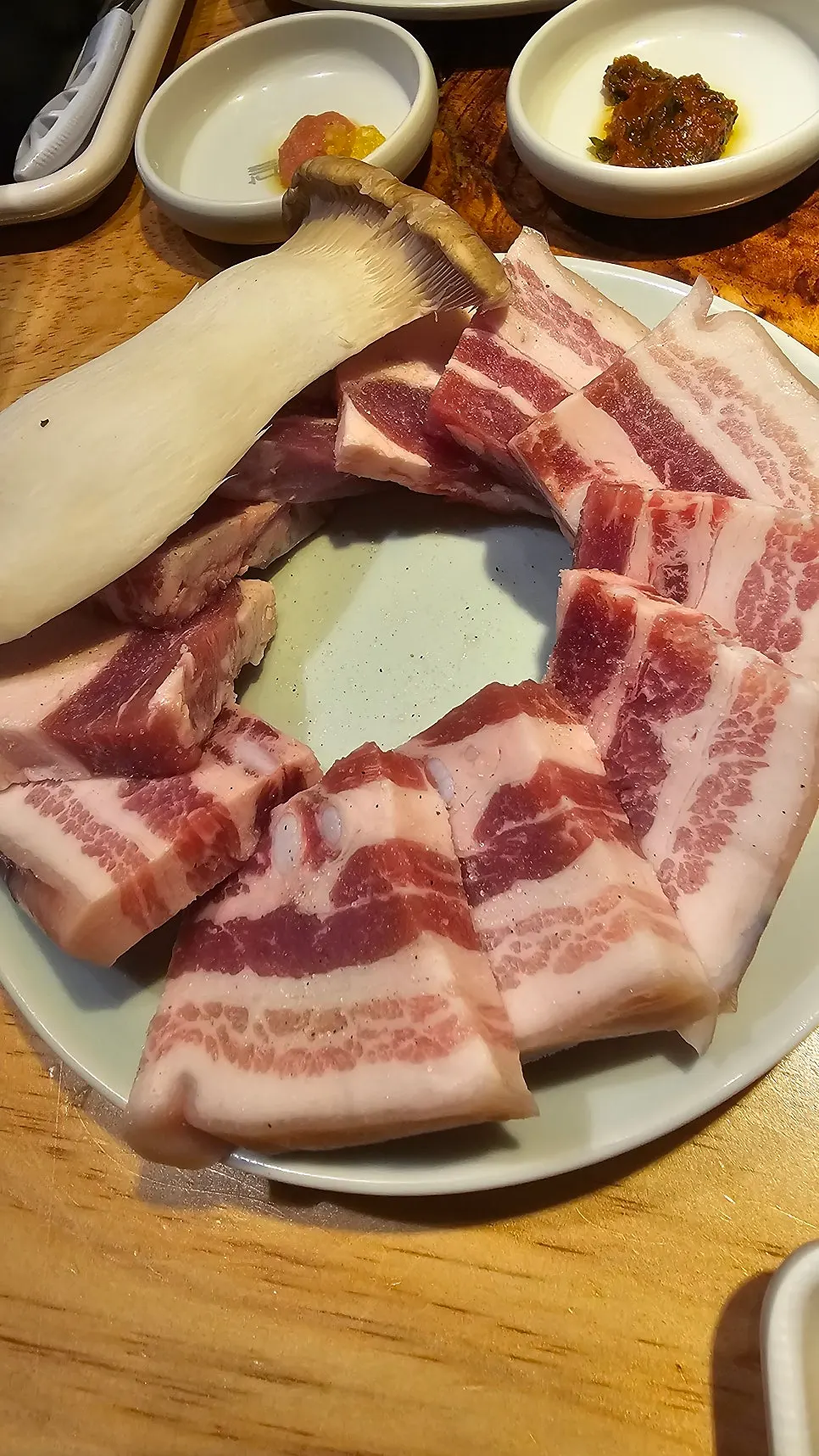 Plate of thick salted pork belly served with mushroom