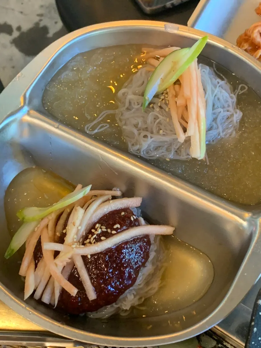 Half-and-half naengmyeon with broth and spicy mixed cold noodles