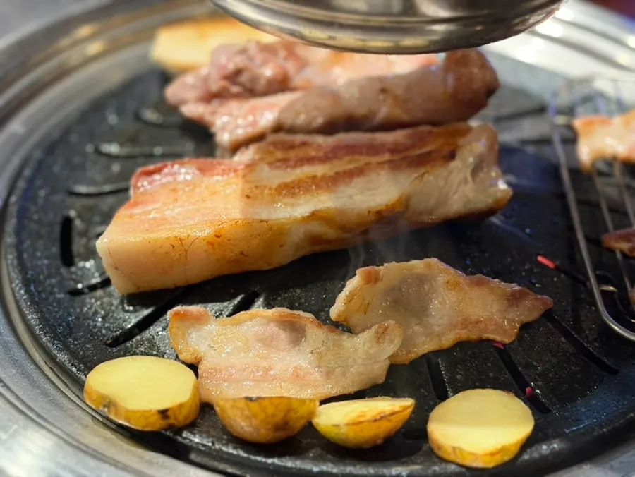 Staff grilling flower pork neck and pork belly