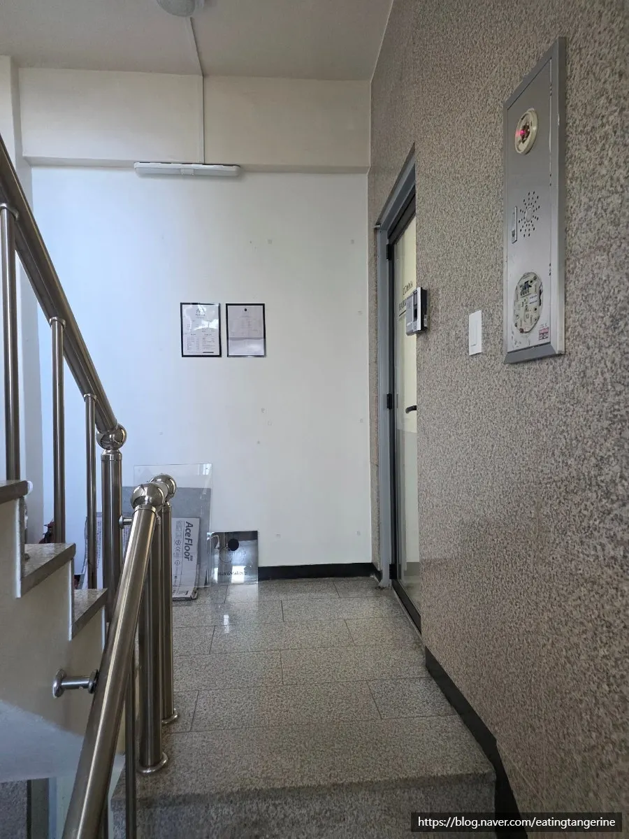 Building exterior and 2nd-floor entrance of Comma Hair & Makeup