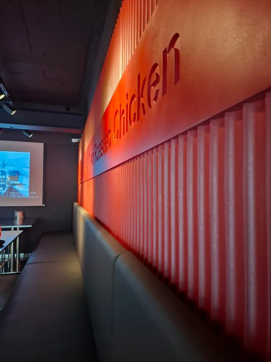 Interior with red wall and Goobne brand history displayed