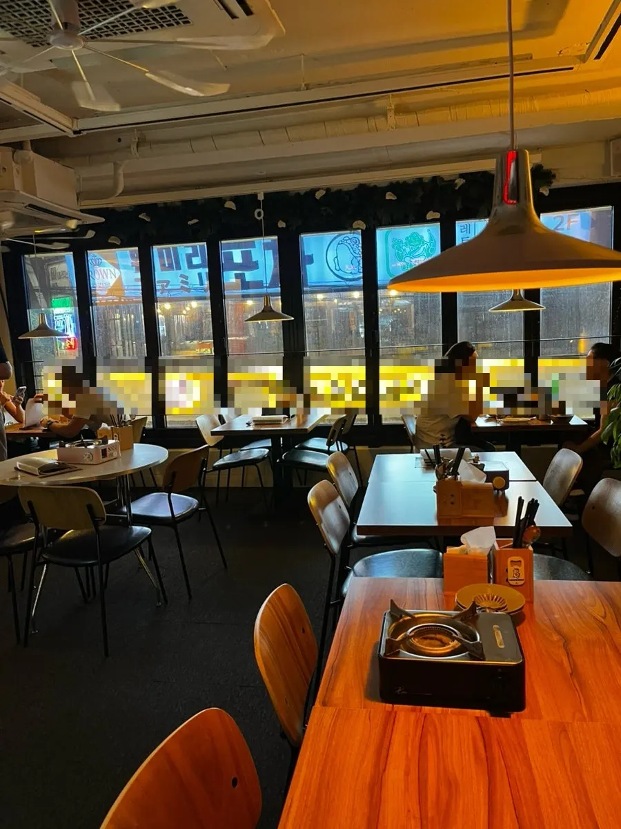 Seating area and self-serve drink station at MANDOO BAR